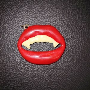 Vintage metal vampire smile pendant